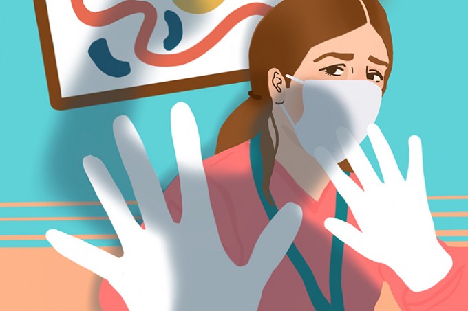 A nurse looks overwhelmed in scrubs, gloves, and a mask. She has her hands up as if preventing someone from hitting her