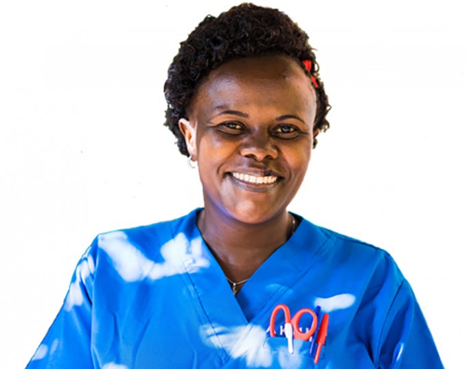 Nurse smiling and wearing scrubs