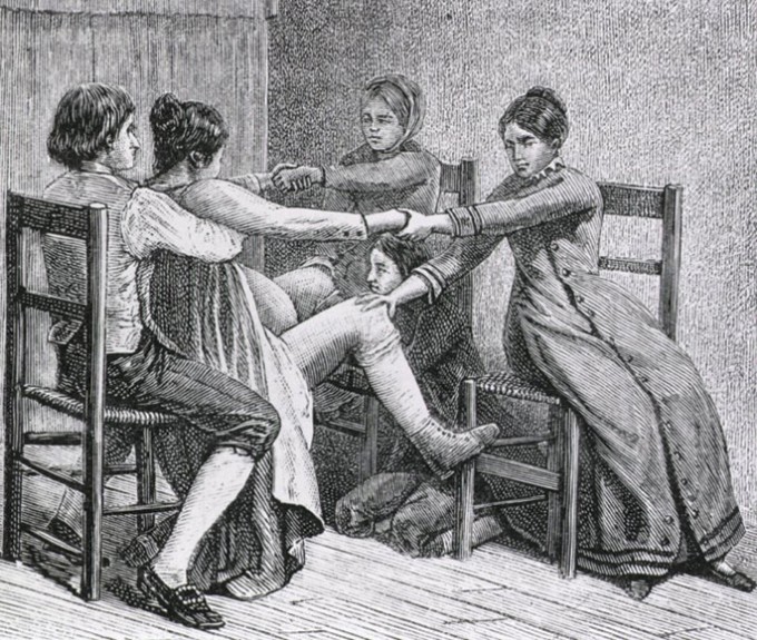 Martha Ballard is delivering a baby while a husband holds his wife on a chair, and two women hold each of the woman's arms