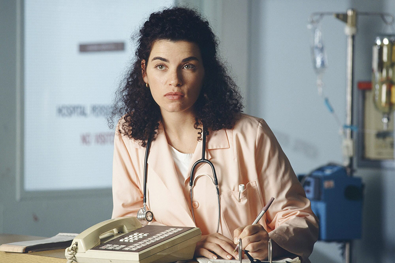 RN Hathaway standing next to phone with scrubs on and stethoscope around her neck
