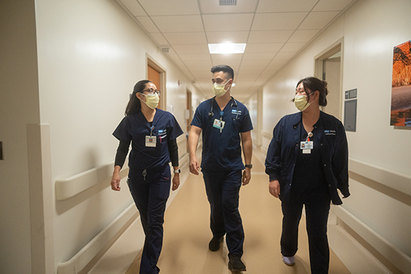 Three nurses, including Devon Ballentine, walking down the hallway at UCLA Santa Monica