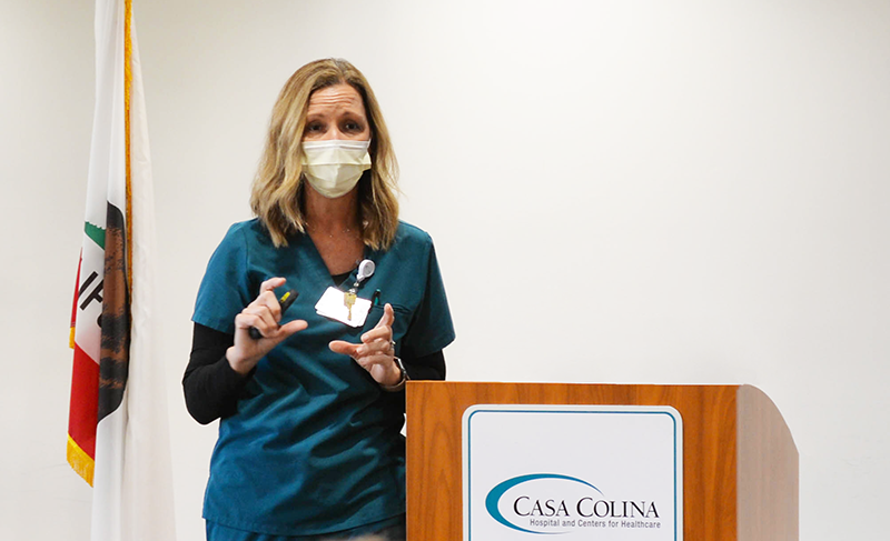 Stephanie Johnstone, a nurse at Casa Colina speaking behind a podium