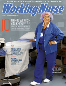 An operating room nurse stands in fronf of a bed in a surgical theater.