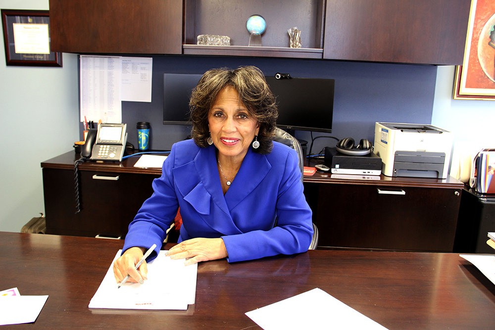 NLN president and CEO Beverly Malone sitting at desk.