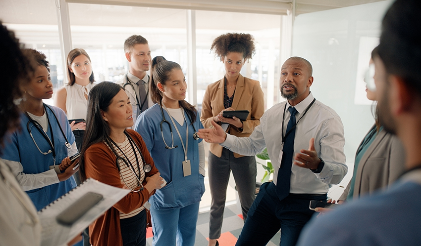 A nursing team gathered around a nurse leader